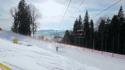 People climb the elevator above the ski slope at a ski resort. Stock Footage 219003716