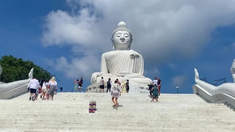 People climb the steps to a large statue on a sunny day. Stock Footage 239523816