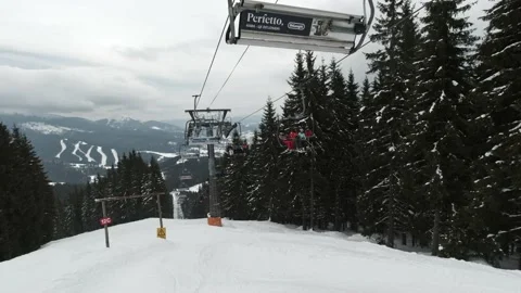 People climbing the elevator at a ski resort on a cloudy day. Stock Footage 219004494