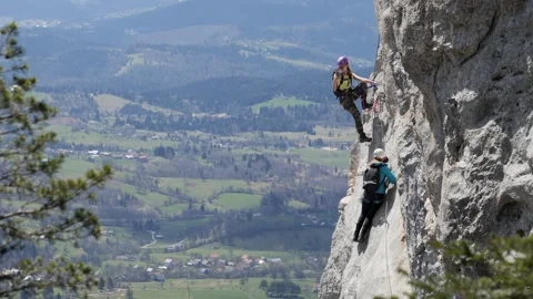 People Climbing Via Ferrata On A Vertica 