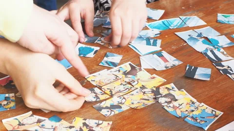 People collect puzzles on the table Stock Footage 88121275