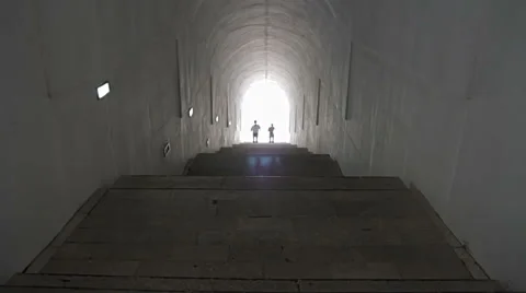 People come into a bright tunnel Stock Footage 53045461