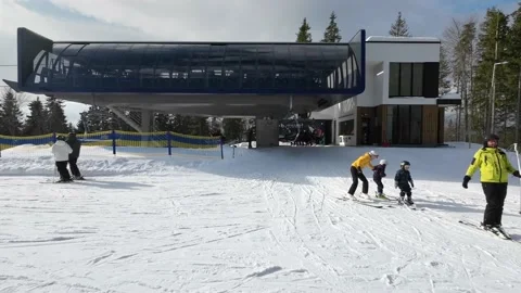 People coming off the ski elevator at the top station Stock Footage 219002116