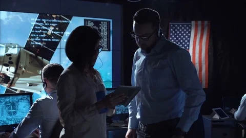 People communicating in space flight center 動画素材 79077323