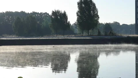 People commute to work with a mist rising off the water. Stock Footage 148043718
