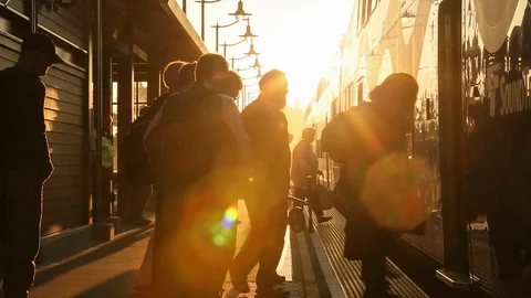 People commuters boarding a train using mass transit at rush hour HD Stock Footage