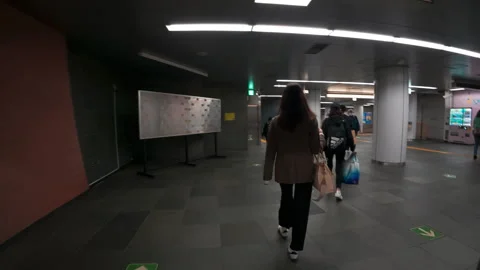 People commuting and walking through a modern underground metro station Stock Footage 330008427