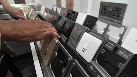 People Compare Electrical Switches and Outlet Panels in Modern Showroom, China Stock Footage 336170352