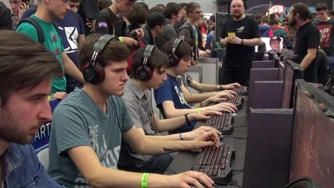 People competing at video games at Comic-Con gaming event Stock Footage 71965106