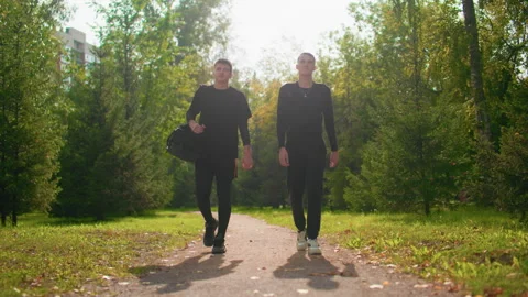People confidently walking along bright leafy trail during workday, Different Stock Footage 325024748