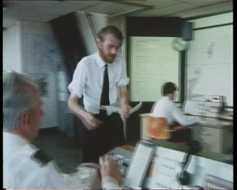 People in control room calling and looking at map, United Kingdom, 1979 Stock Footage 142214852