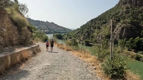 People couple walking down the path next to river Caminito del Rey Video stock 220741571