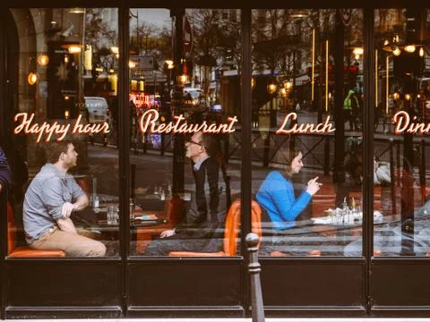 People couples having lunch in central Paris cafe glass Stock Photos