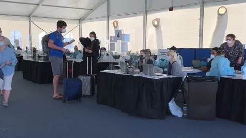 People at a Covid 19 testing facility provided by Norwegian Cruise Line prior Stock Footage 168695810