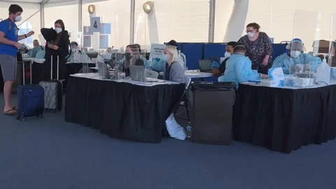 People at a Covid 19 testing facility provided by Norwegian Cruise Line prior Stock Footage 168695824