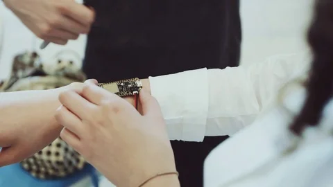People creating and designing new technology which will be used on the hand Stock Footage 76829355
