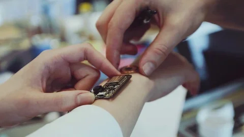 People creating and designing new technology which will be used on the hand Stock Footage 76829376