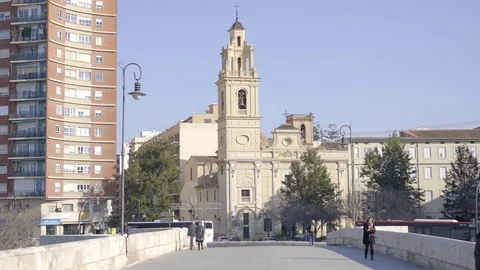 People crossing Bridge with Church in background.- Valencia Spain Stock Footage 73277553