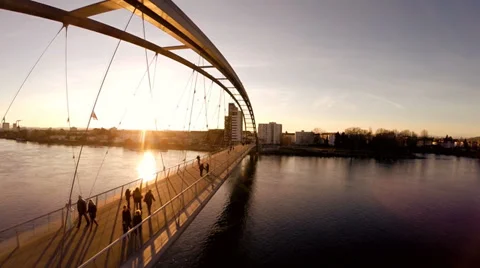 People crossing bridge. fly over. aerial view. bridge. sunset Stock Footage