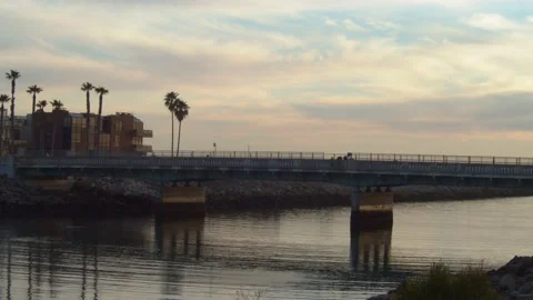 People Crossing A Bridge At Sunset Video stock 171400901