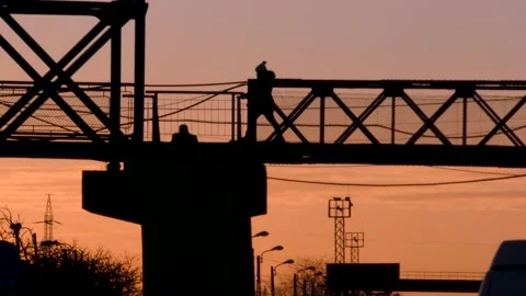 People crossing bridge at sunset Video stock 171863465