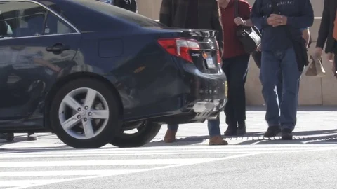 People crossing busy intersection Stock Footage 74365170