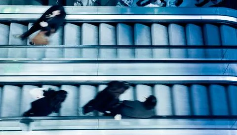 People on crossing Escalators Stock Photos