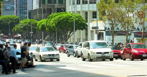 People crossing intersection and traffic jam during rush hour in Los Angeles 4K Video stock 66960164