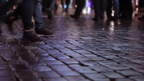 People crossing square. Flow on paving stone. Evening. Crowd. Wet pavement. Stock Footage