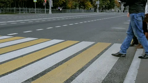 People crossing the street at a pedestrian crossing Stock Footage