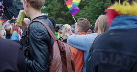 People crowd dance and enjoy Oslo Pride 2022 with colorful outfits and Stock Footage 220761704
