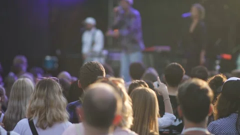 People crowd making party, dancing on rock concert in stadium on summer day. Stock Footage 119904360