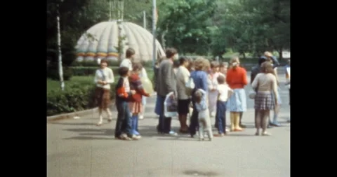 People crowd queue in amusement park in sunny summer. Children, parents line Stock Footage 245228515
