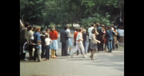 People crowd queuing at ticket office of amusement park. Happy people in Stock Footage 245415015