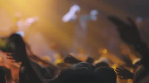 People in the crowd swing their arms to the sides at a live rap concert Stock Footage 241166455
