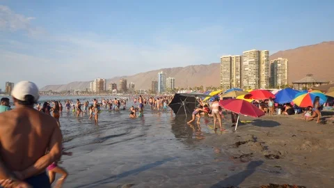 People at Crowded Beach. Camera Moves Forward Parallel to Coastline. 스톡 동영상 103334837
