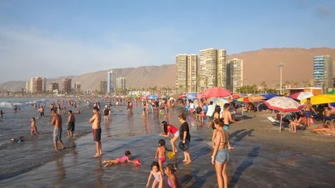People at Crowded Beach. Camera Moves Forward Parallel to Coastline. 스톡 동영상 103334857