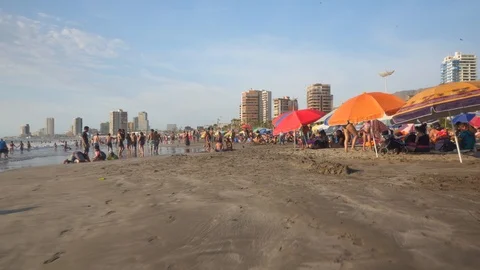 People at Crowded Beach. Camera Moves Forward Parallel to Coastline. 스톡 동영상 103335011