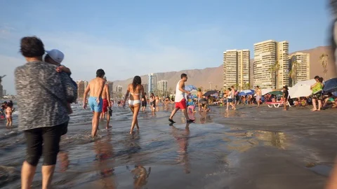 People at Crowded Beach. Camera Moves Forward Parallel to Coastline. 스톡 동영상 103335013