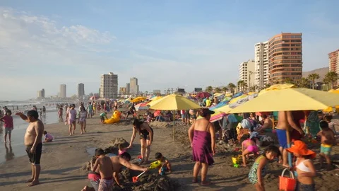 People at Crowded Beach. Camera Moves Forward Parallel to Coastline. 스톡 동영상 103335333