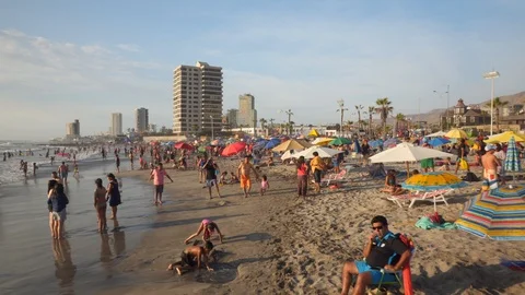 People at Crowded Beach. Camera Moves Forward Parallel to Coastline. 스톡 동영상 103335443