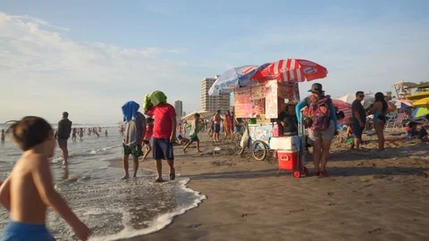 People at Crowded Beach. Camera Moves Forward Parallel to Coastline. 스톡 동영상 103335472