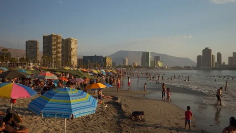 People at Crowded Beach. Camera Moves Forward Parallel to Coastline. 스톡 동영상 103335571