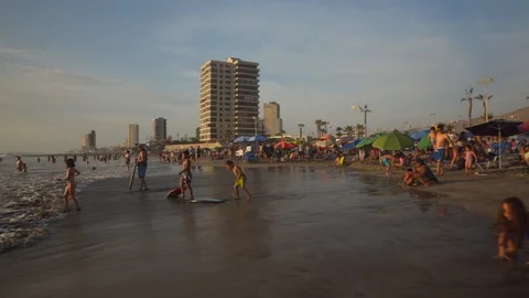 People at Crowded Beach. Camera Moves Forward Parallel to Coastline. 스톡 동영상 103335578