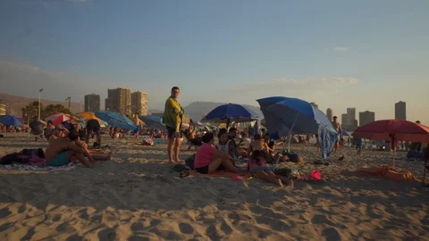 People at Crowded Beach. Camera Moves Forward Parallel to Coastline. 스톡 동영상 103336489