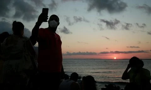 People crowded during sunset Stock Photos