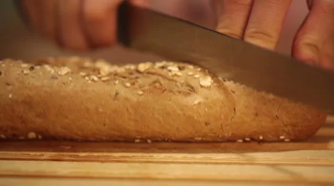 People cutting whole wheat bread baguette into small pieces Stock Footage 68455015