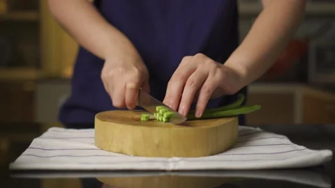 People cutting Yard long beans on wooden cutting board, front view Stock Footage 147745589