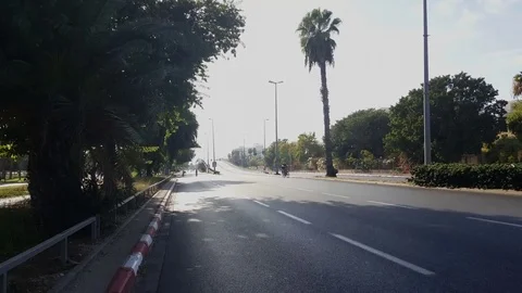 People cycle on empty Rokach road, Yom Kippur 2016, sunny day, Tel-Aviv, Israel Stockbeeldmateriaal 80260458