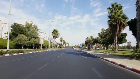 People cycle on empty Rokach road, Yom Kippur 2016, sunny day, palm trees Видео 80262699